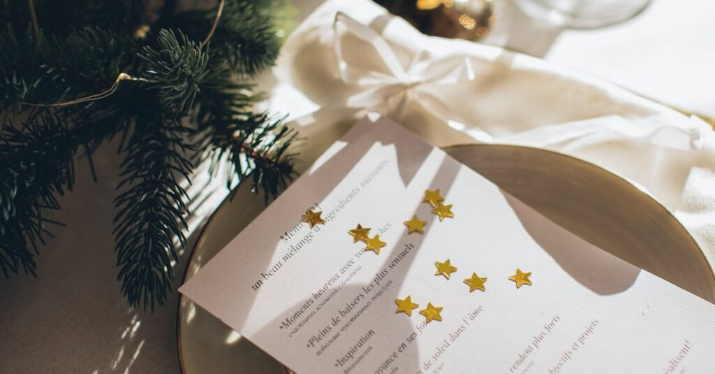Festive table setting featuring a menu card with stars, elegant cutlery, and holiday decor.