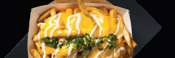 istockphoto-1405216633-2048×2048 Loaded Cheese Fries served in a box isolated on wooden board top view on black background fast food
